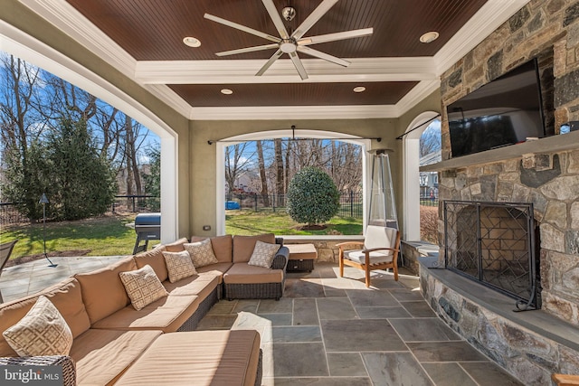 view of patio / terrace featuring grilling area, an outdoor living space with a fireplace, ceiling fan, and fence