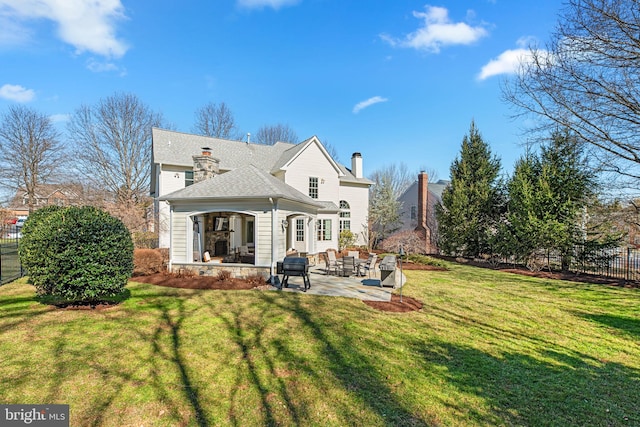 rear view of property with a patio area, fence, and a lawn