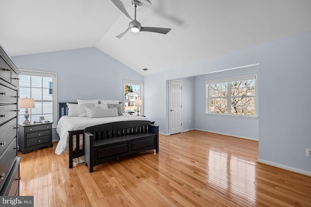 bedroom with light wood-type flooring, multiple windows, lofted ceiling, and visible vents