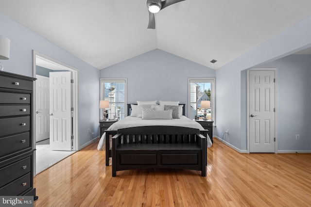 bedroom featuring light wood finished floors, visible vents, ceiling fan, baseboards, and vaulted ceiling