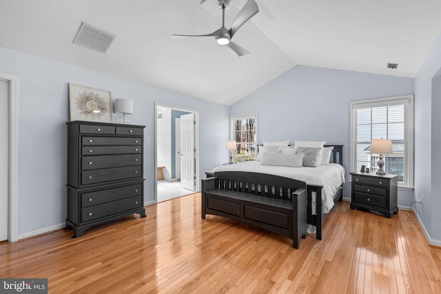 bedroom featuring vaulted ceiling, light wood-style flooring, multiple windows, and visible vents