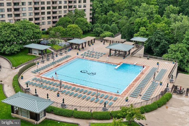 view of swimming pool with fence and a gazebo