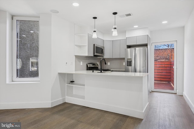 kitchen featuring visible vents, appliances with stainless steel finishes, a peninsula, gray cabinetry, and open shelves