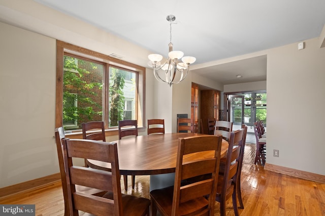 5724 4th St NW, Washington, DC 20011 - dining area featuring a chandelier, light wood-style flooring, and healthy amount of natural light
