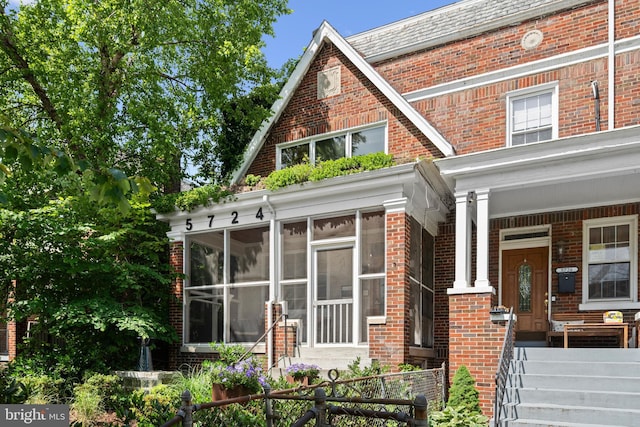 5724 4th St NW, Washington, DC 20011 - view of front of property featuring brick siding, a sunroom, and a porch