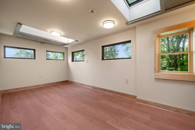 5724 4th St NW, Washington, DC 20011 - unfurnished room featuring a skylight, light wood finished floors, and baseboards