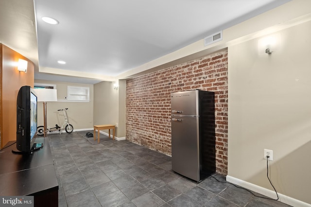 5724 4th St NW, Washington, DC 20011 - unfurnished living room featuring brick wall, baseboards, and recessed lighting