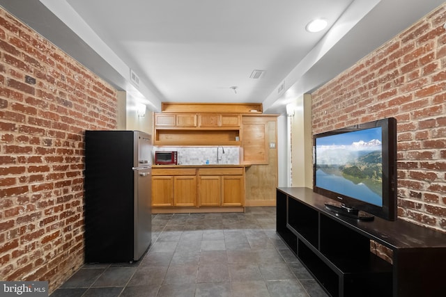 5724 4th St NW, Washington, DC 20011 - kitchen featuring freestanding refrigerator, brick wall, and open shelves
