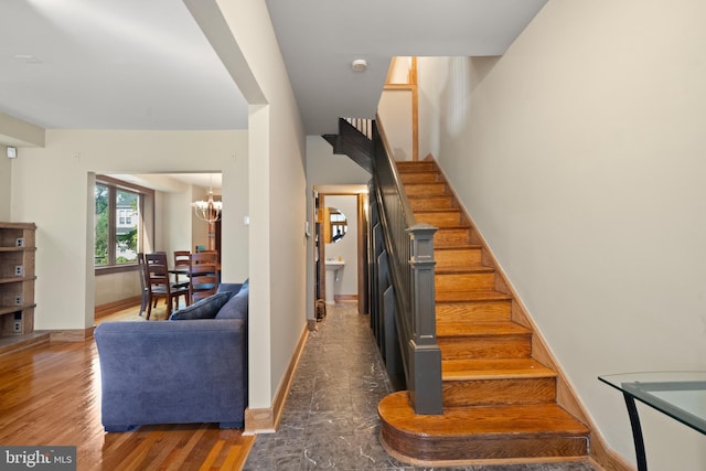 5724 4th St NW, Washington, DC 20011 - staircase with a chandelier, wood finished floors, and baseboards