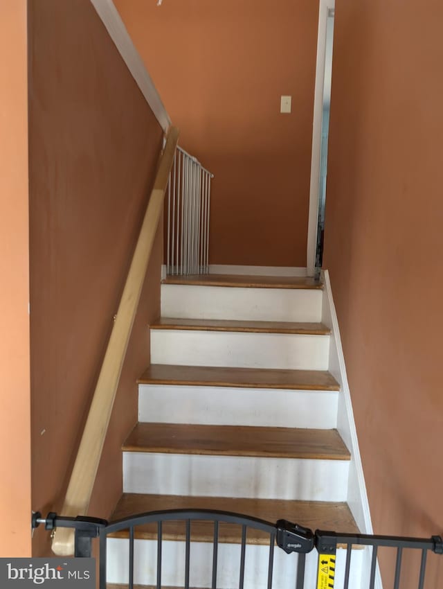 stairway featuring baseboards