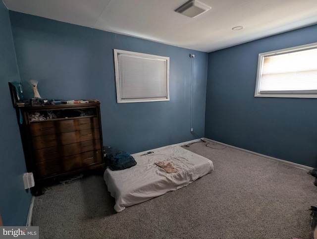 unfurnished bedroom featuring carpet flooring, baseboards, and visible vents