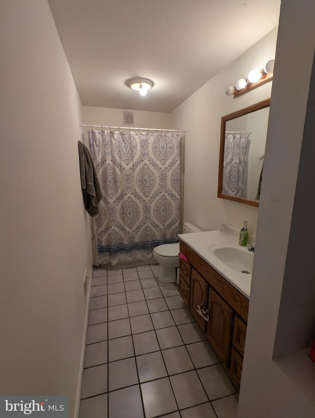 bathroom with a shower with shower curtain, toilet, vanity, and tile patterned flooring