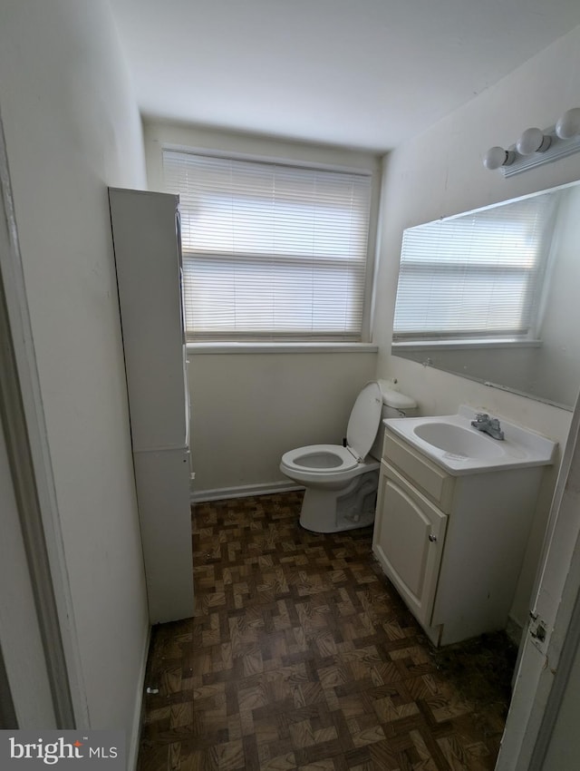 half bathroom with toilet and vanity