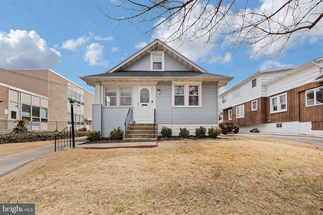 view of front of home with entry steps and a front yard