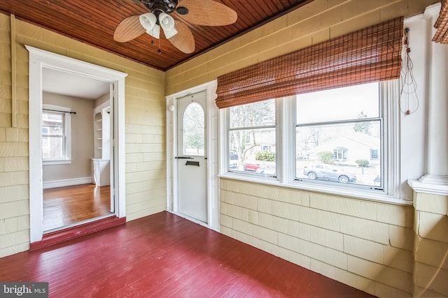 unfurnished sunroom with ceiling fan and wooden ceiling