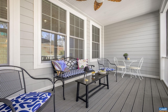 wooden terrace featuring a porch and a ceiling fan