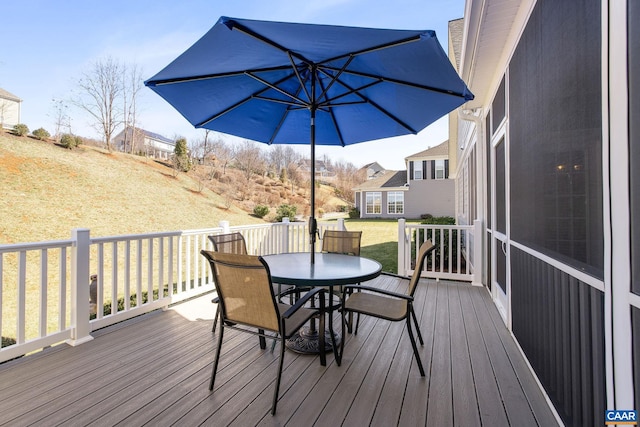 wooden deck with a yard and outdoor dining space