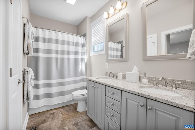 full bathroom featuring visible vents, a sink, toilet, and double vanity