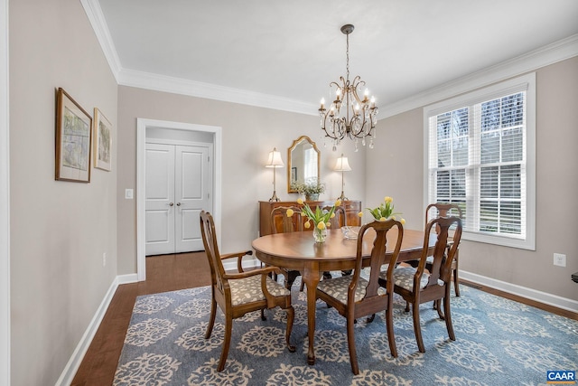 dining space with crown molding, baseboards, a chandelier, and wood finished floors