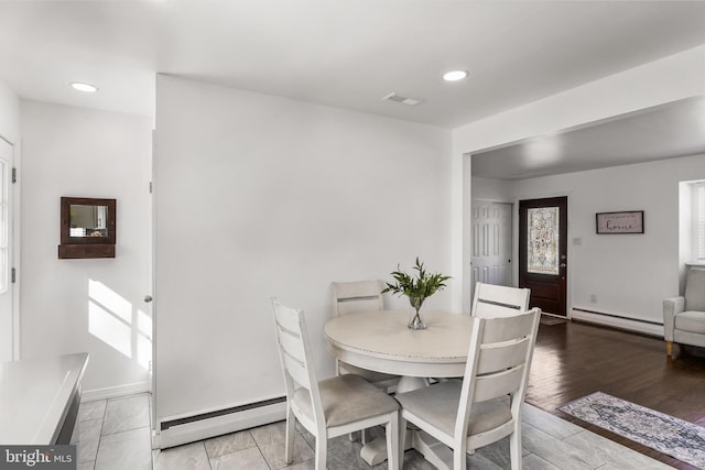 dining room with light wood finished floors, baseboards, a baseboard radiator, baseboard heating, and recessed lighting