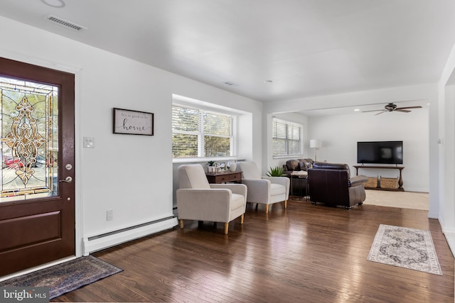 entryway featuring a ceiling fan, a baseboard radiator, visible vents, and wood finished floors