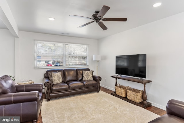 living room featuring recessed lighting, wood finished floors, visible vents, and baseboards