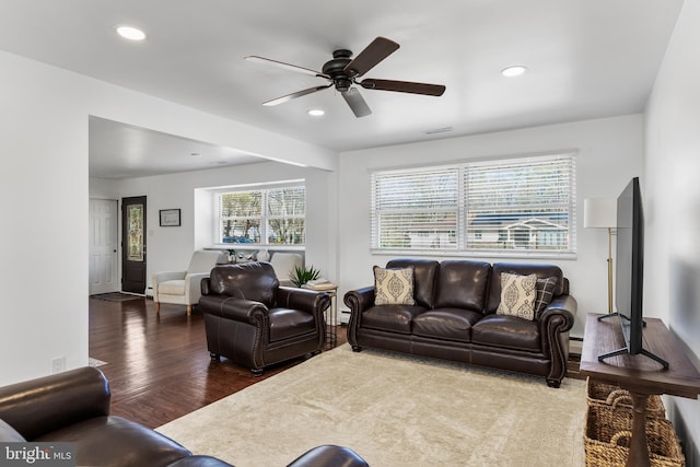 living room featuring a ceiling fan, recessed lighting, visible vents, and wood finished floors