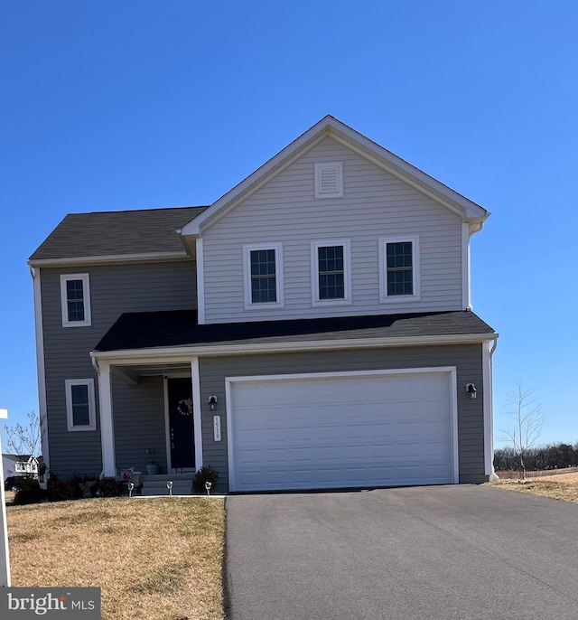 traditional-style house featuring driveway and an attached garage