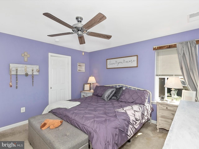 carpeted bedroom with baseboards, visible vents, and a ceiling fan