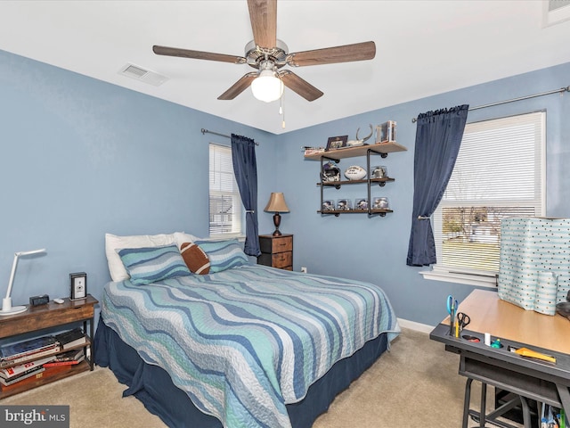 carpeted bedroom featuring ceiling fan, visible vents, and baseboards