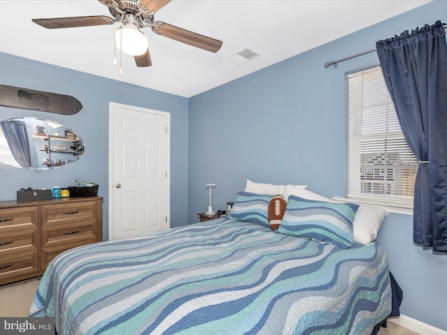 bedroom featuring a ceiling fan, carpet, and visible vents