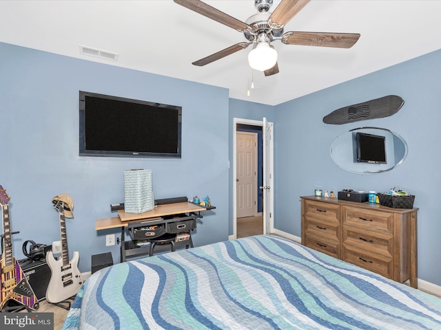 carpeted bedroom featuring ceiling fan, visible vents, and baseboards