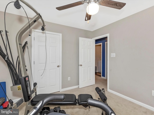 workout area featuring a ceiling fan, baseboards, and carpet flooring