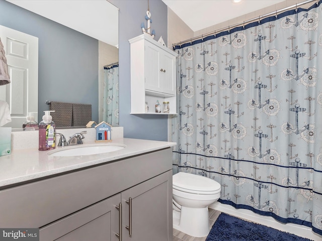 bathroom featuring tile patterned flooring, vanity, toilet, and a shower with curtain