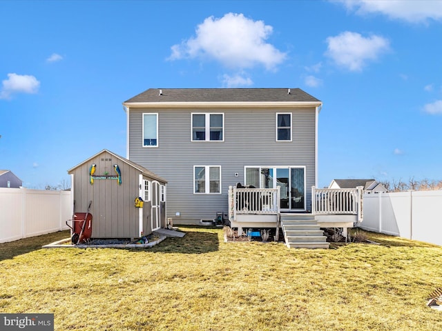 rear view of house with a wooden deck, a fenced backyard, a yard, a shed, and an outdoor structure