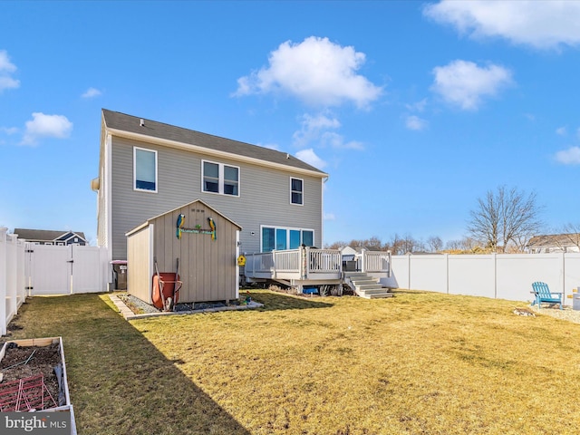 rear view of house featuring a garden, a fenced backyard, a lawn, and a deck