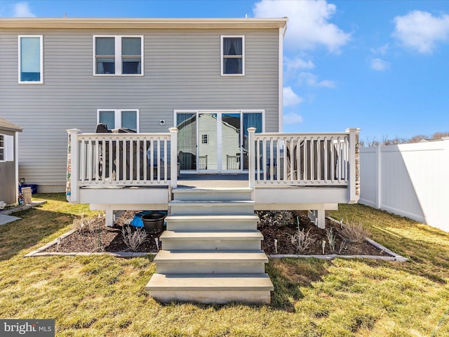 rear view of house featuring a yard, stairs, fence, and a wooden deck