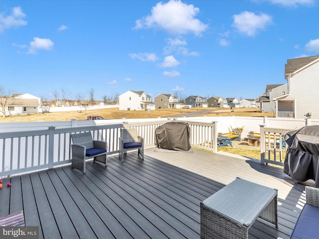 deck with a residential view and grilling area