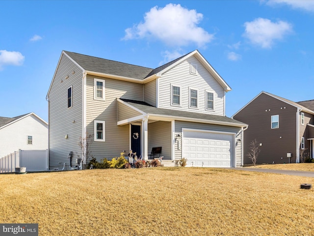 traditional home with a front yard and an attached garage