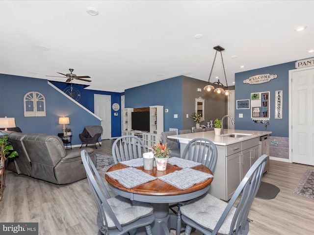 dining space with recessed lighting, light wood-type flooring, a ceiling fan, and baseboards