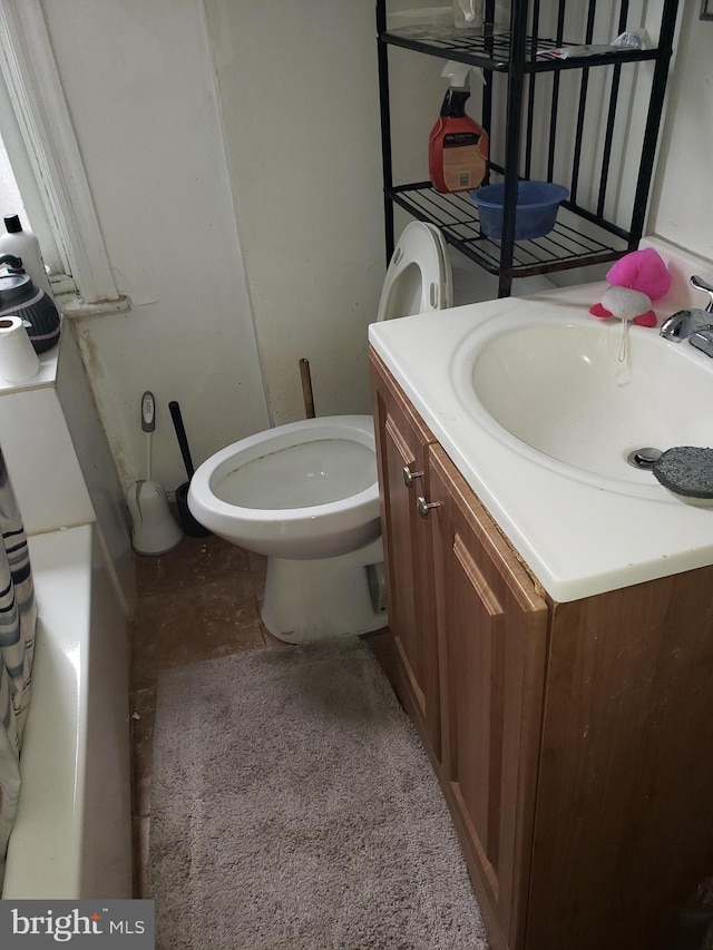 bathroom featuring toilet and vanity