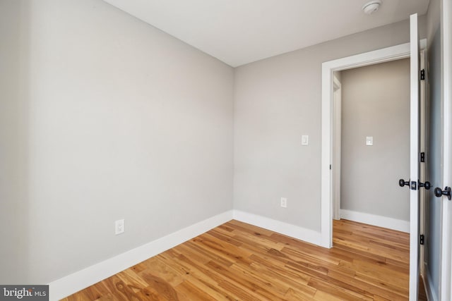 spare room with light wood-style floors and baseboards