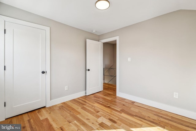 unfurnished bedroom featuring light wood finished floors and baseboards