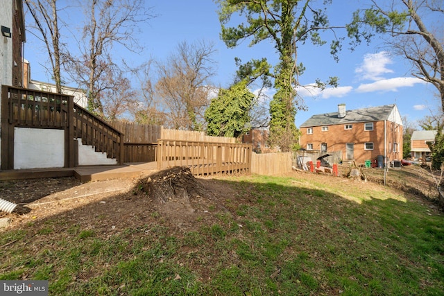 view of yard featuring stairs and fence