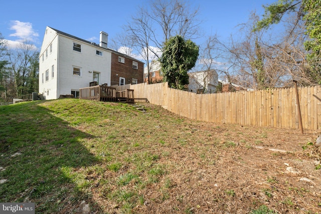 view of yard with a wooden deck and fence