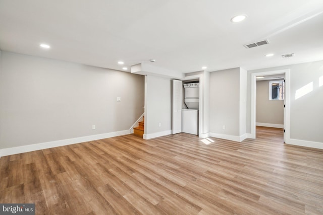 finished below grade area with stairway, recessed lighting, visible vents, and light wood-type flooring