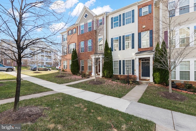 view of property with a residential view and brick siding