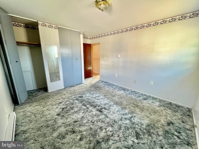 unfurnished bedroom featuring multiple closets, carpet floors, a baseboard radiator, and baseboards