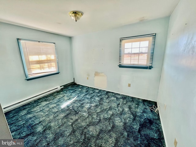 unfurnished room featuring a baseboard heating unit and carpet