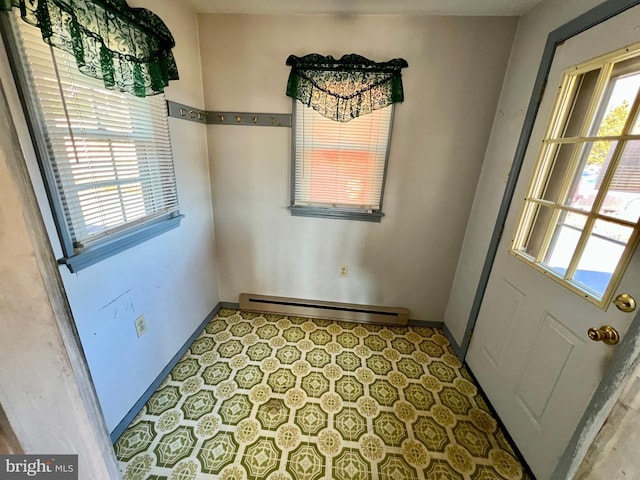 unfurnished dining area featuring a baseboard radiator and baseboards